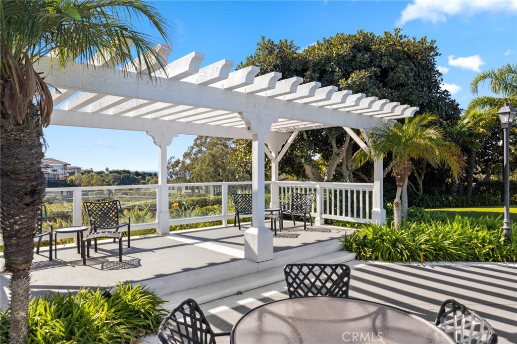 3521 Geranium Avenue, Unit 22 Corona del Mar, CA 92625 - Photo 37 of 37 a view of a patio with couches table and chairs potted plants with lake view