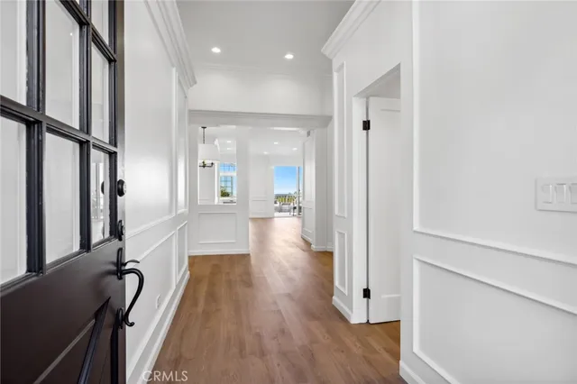 a view of a hallway with wooden floor and staircase