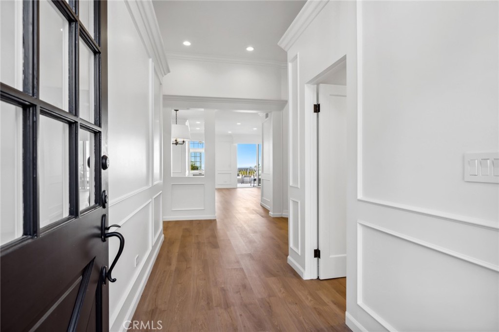 3521 Geranium Avenue, Unit 22 Corona del Mar, CA 92625 - Photo 5 of 37 a view of a hallway with wooden floor and staircase