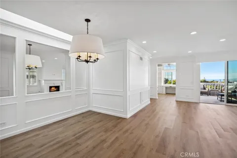 a view of a livingroom with wooden floor and a ceiling fan