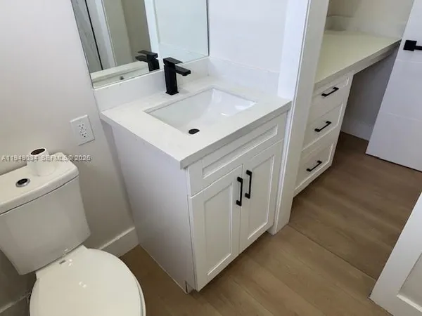 a bathroom with a sink toilet and mirror