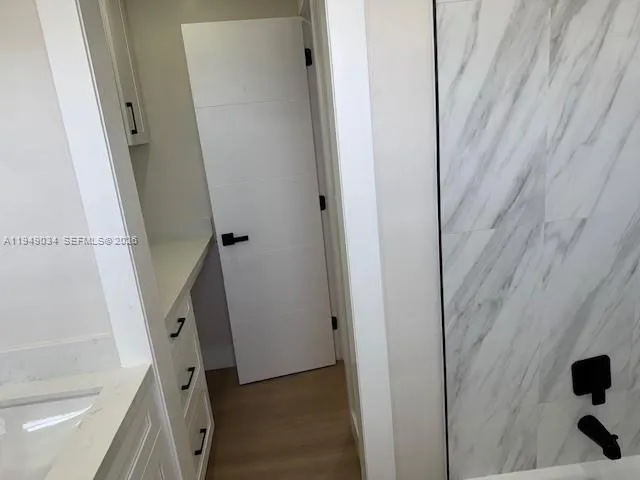 a bathroom with a sink and a shower