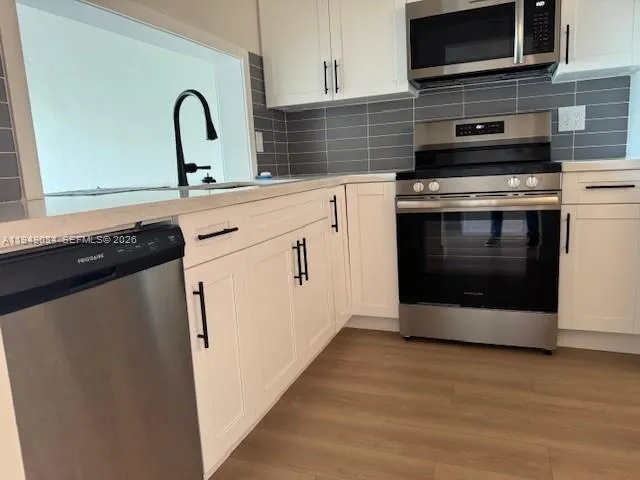 a kitchen with a stove and a microwave