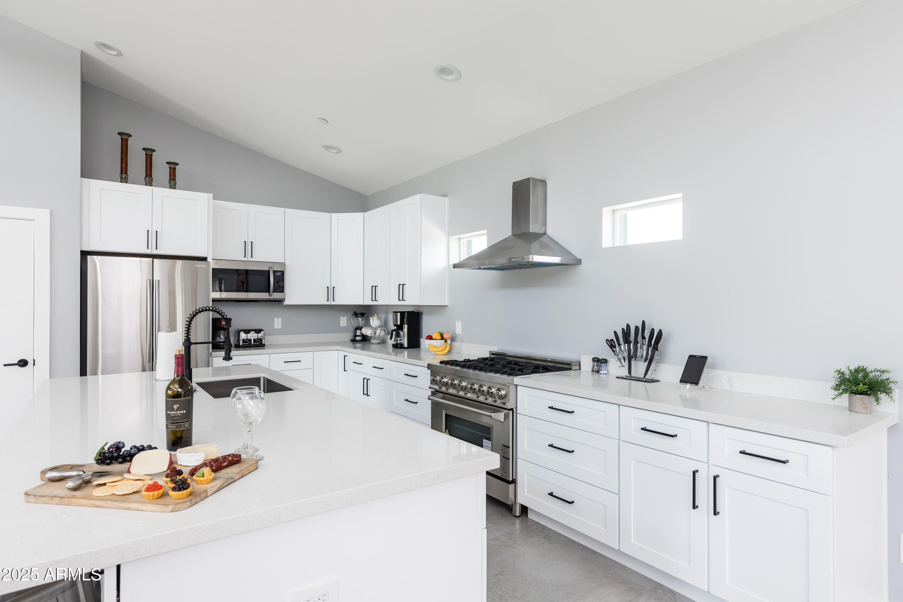 3043 North 85th Place Scottsdale, AZ 85251 - Photo 13 of 33 a kitchen with white cabinets stainless steel appliances and sink