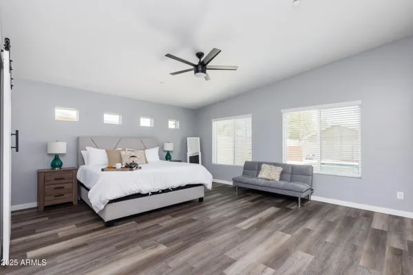 a bedroom with bed and a chandelier