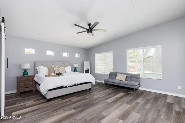 a bedroom with bed and a chandelier