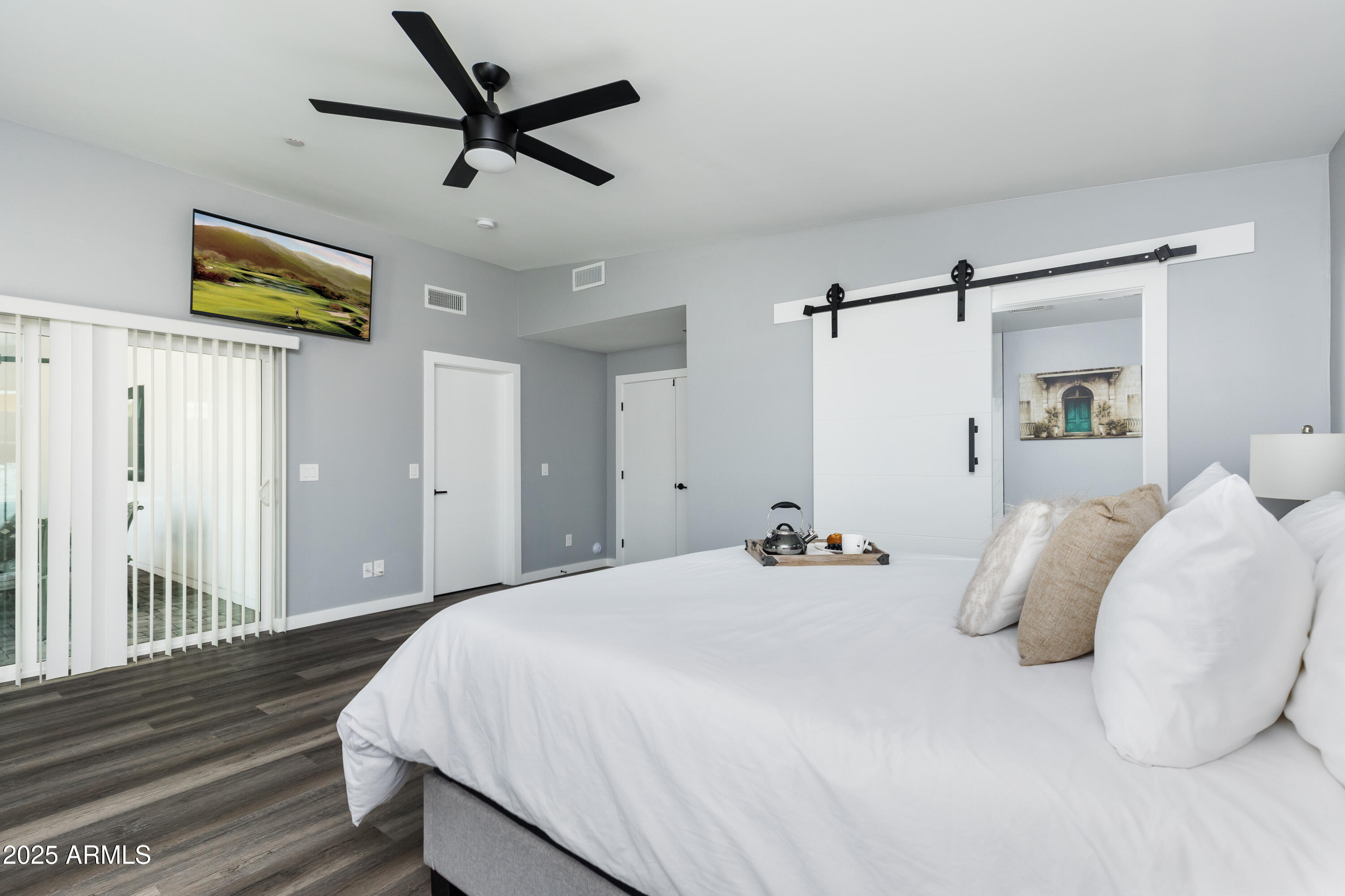 3043 North 85th Place Scottsdale, AZ 85251 - Photo 15 of 33 a bedroom with bed and a chandelier