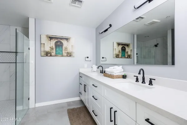 a spacious bedroom with a bed and wooden floor