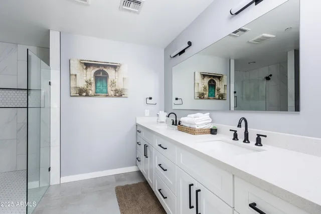 a spacious bedroom with a bed and wooden floor