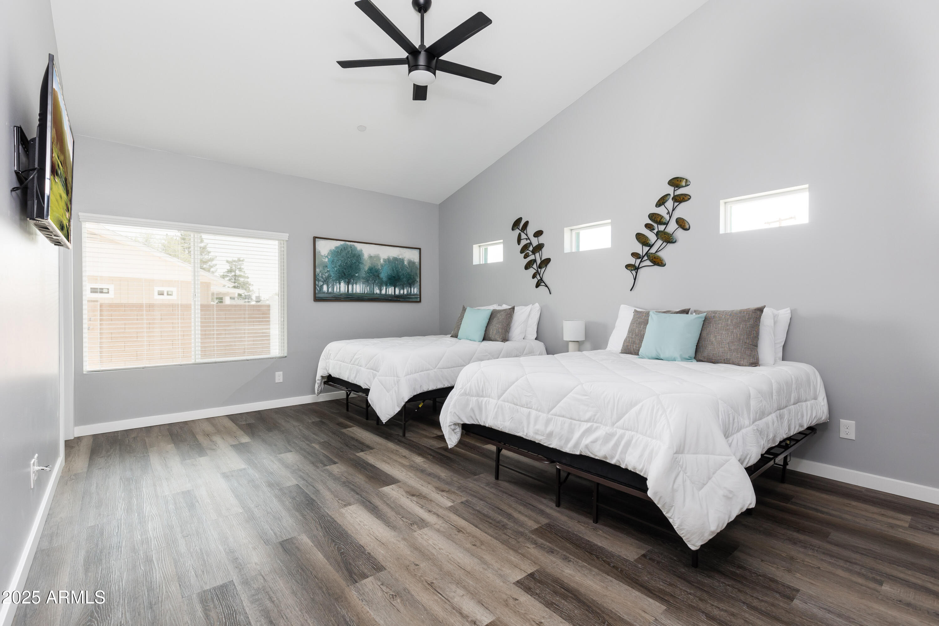 3043 North 85th Place Scottsdale, AZ 85251 - Photo 18 of 33 a spacious bedroom with a bed and wooden floor