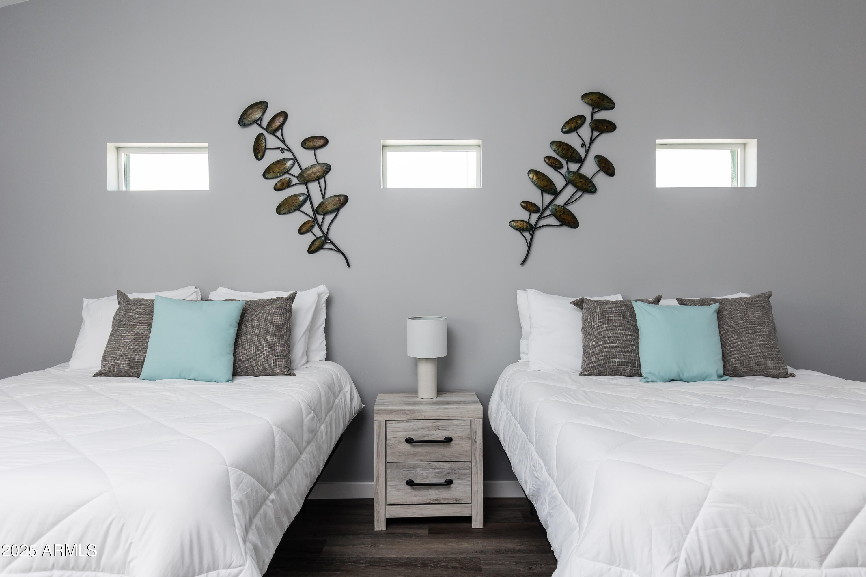 3043 North 85th Place Scottsdale, AZ 85251 - Photo 19 of 33 a bedroom with a bed and a chandelier