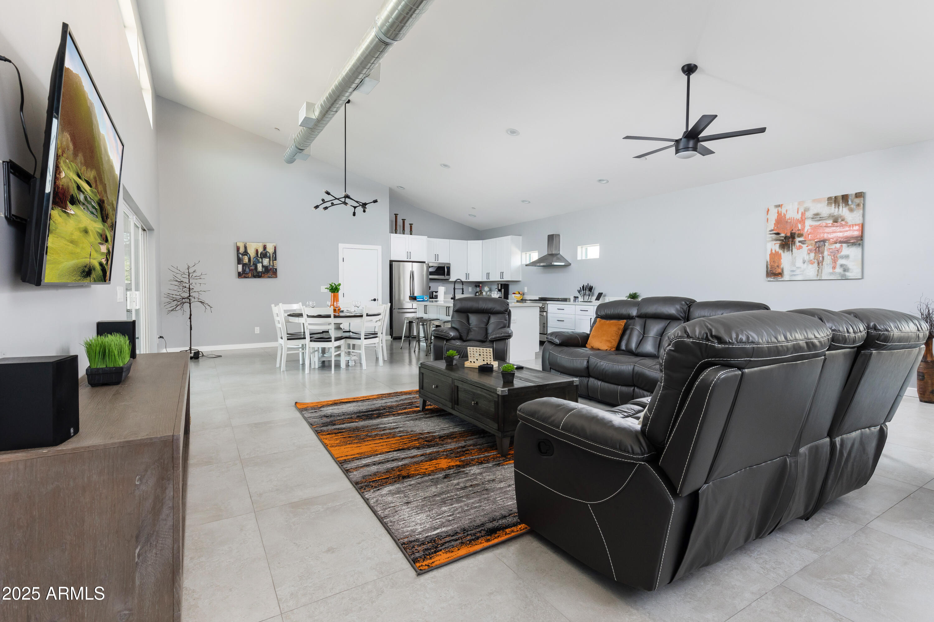 3043 North 85th Place Scottsdale, AZ 85251 - Photo 2 of 33 a living room with furniture and a flat screen tv