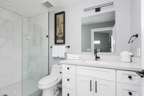 a bedroom with a large bed and a potted plant