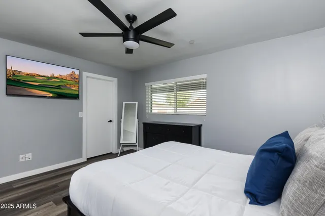 a bedroom with a bed and a window