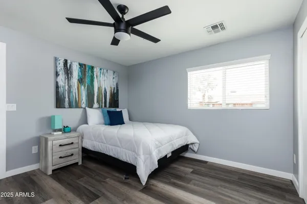 a bedroom with a bed and a chandelier