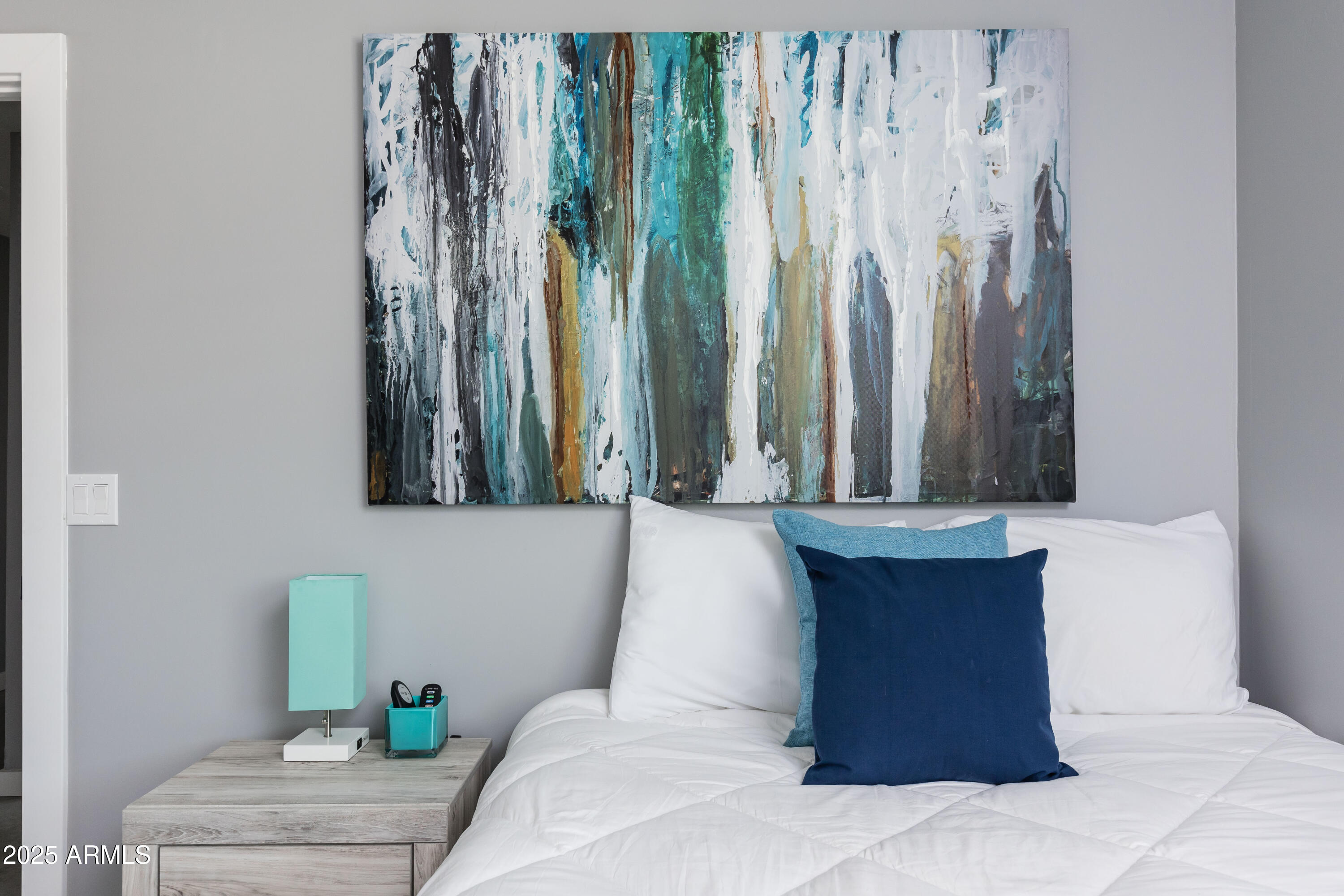 3043 North 85th Place Scottsdale, AZ 85251 - Photo 27 of 33 a bedroom with a bed and a chandelier