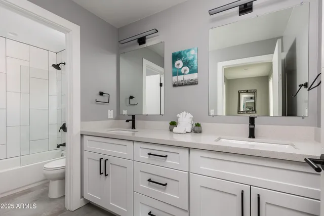 a kitchen with cabinets and washer dryer