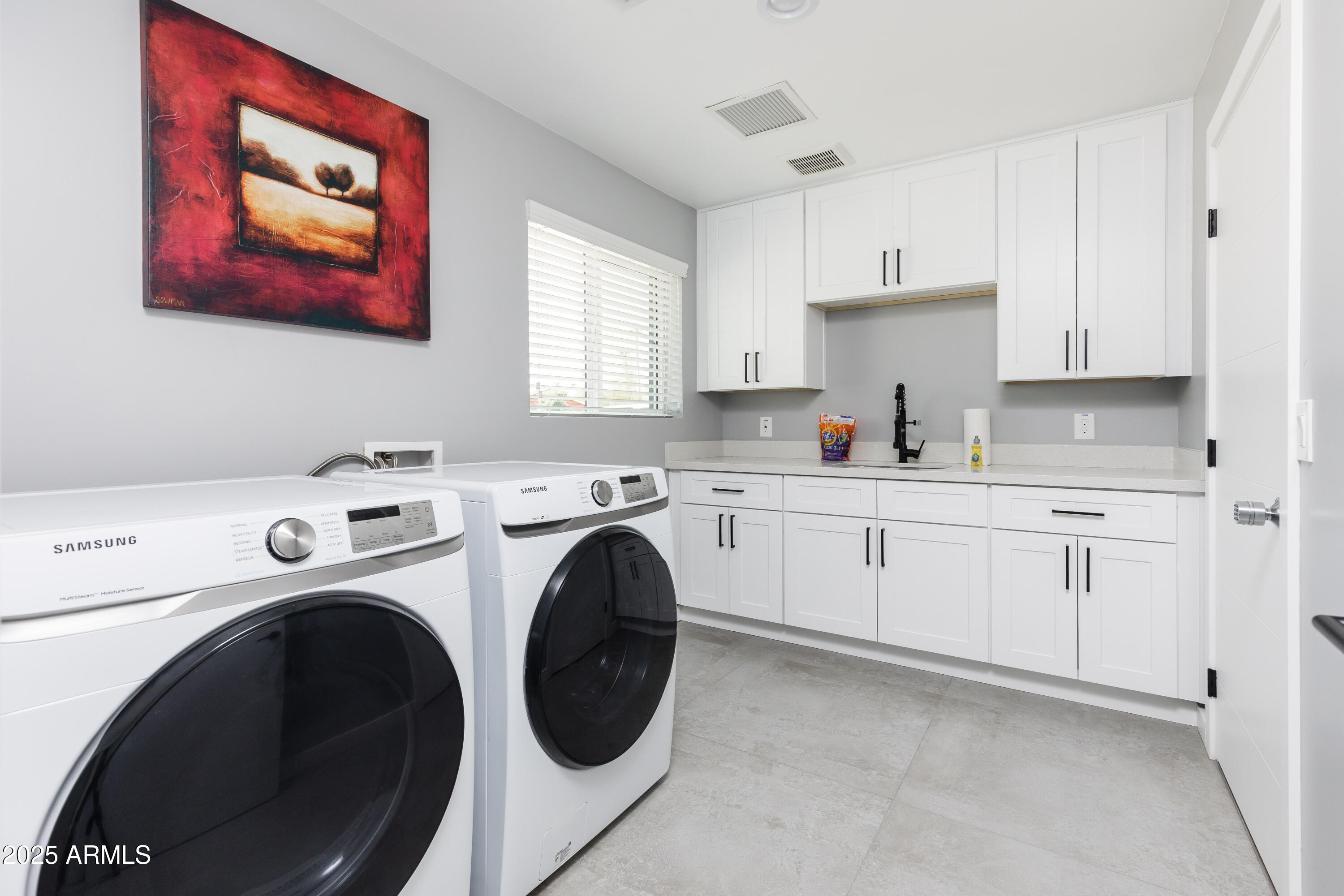 3043 North 85th Place Scottsdale, AZ 85251 - Photo 30 of 33 a kitchen with cabinets and washer dryer