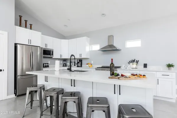a kitchen with stainless steel appliances a refrigerator and a stove top oven
