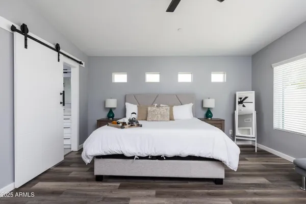 a bedroom with a bed and a night stand