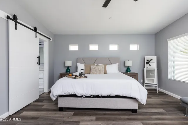 a bedroom with a bed and a night stand