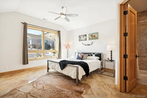 a spacious bedroom with a bed and a window