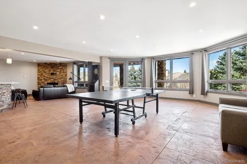 a living room with furniture a table and large windows