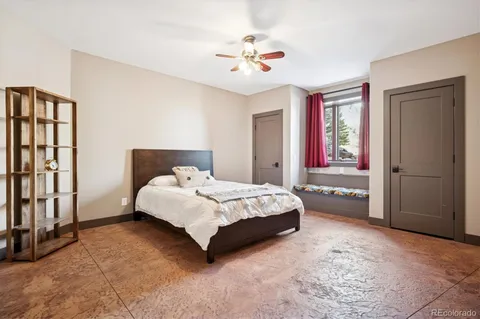 a spacious bedroom with a bed and a chandelier