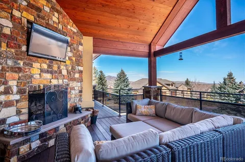 a terrace with outdoor seating and city view