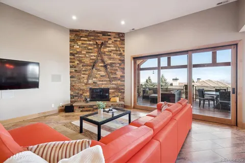 a outdoor living space with furniture and a flat screen tv