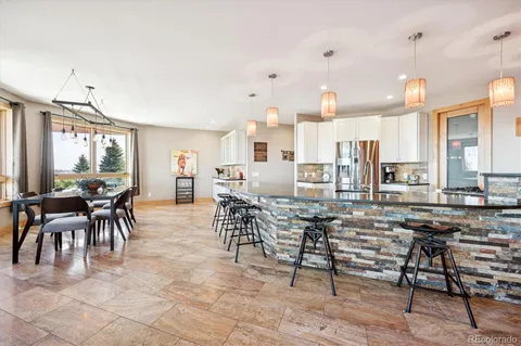 a large kitchen with a table and chairs