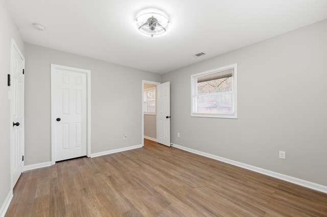 2332 Barge Road Southwest Atlanta, GA 30331 - Photo 10 of 30 a view of an empty room with wooden floor and a window