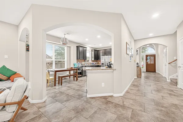 a kitchen with refrigerator and cabinets