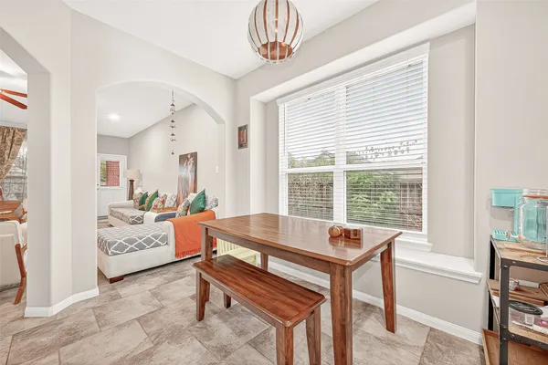 a kitchen with granite countertop a refrigerator and a stove top oven