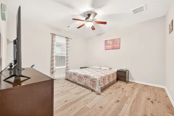 a bedroom with a bed and a flat screen tv