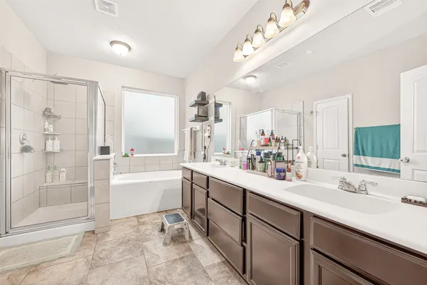 a bathroom with a sink a mirror toilet and bathtub