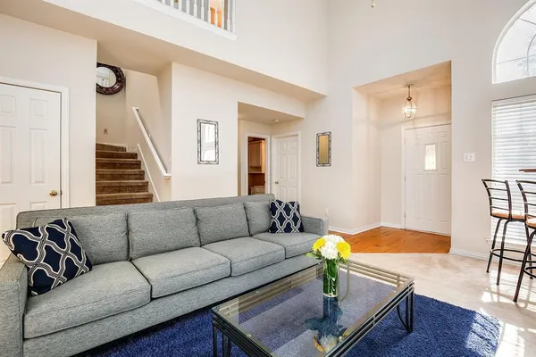 a living room with furniture and a dining table