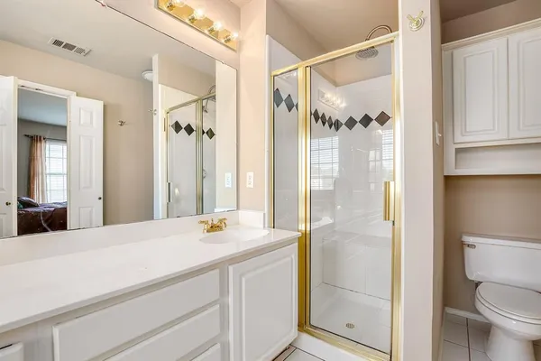 a bathroom with a shower sink and mirror