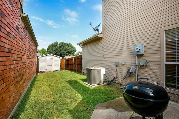 a view of a backyard with a garden and entertaining space