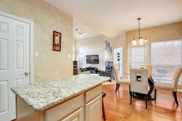 a living room with dining table and chairs
