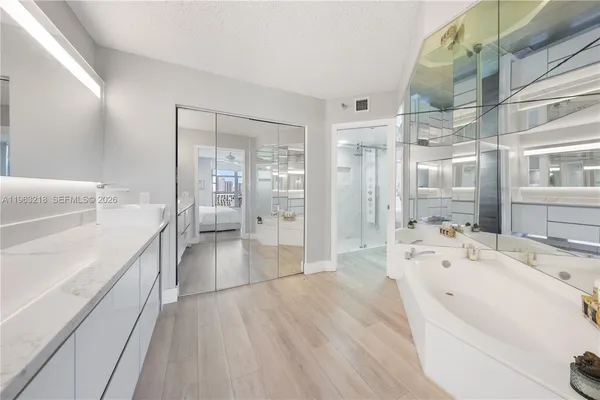 a spacious bathroom with a bathtub shower and sink