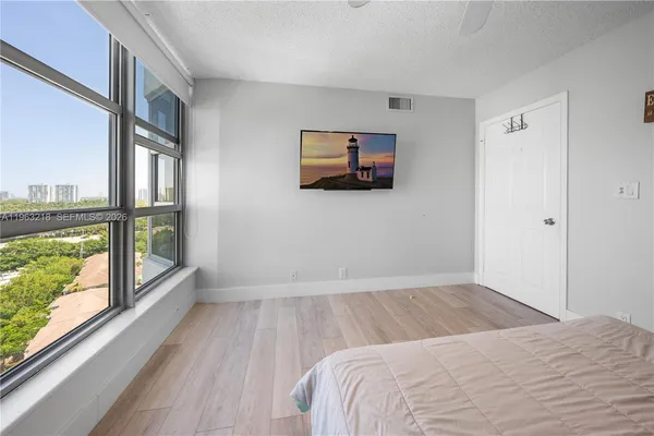 a bedroom with a bed and a large window