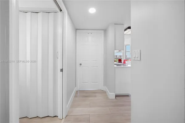 a utility room with cabinets washer and dryer