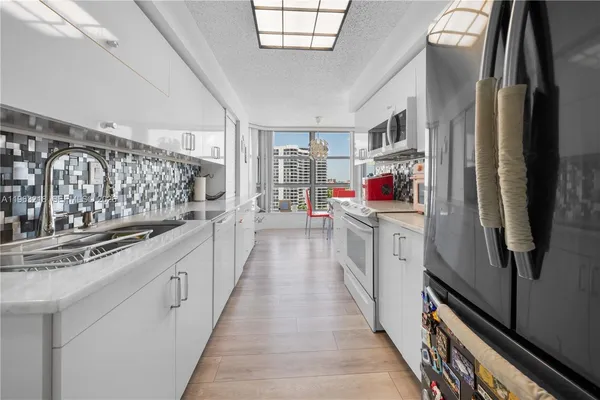 a bedroom with furniture and a large window