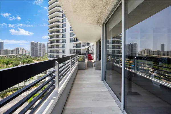 a view of a balcony with wooden floor and city view
