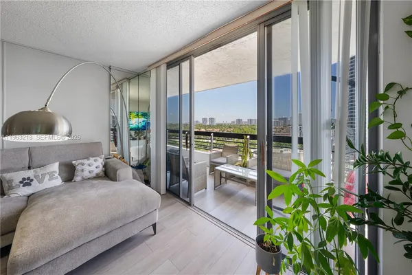 a bedroom with a large bed and a potted plant
