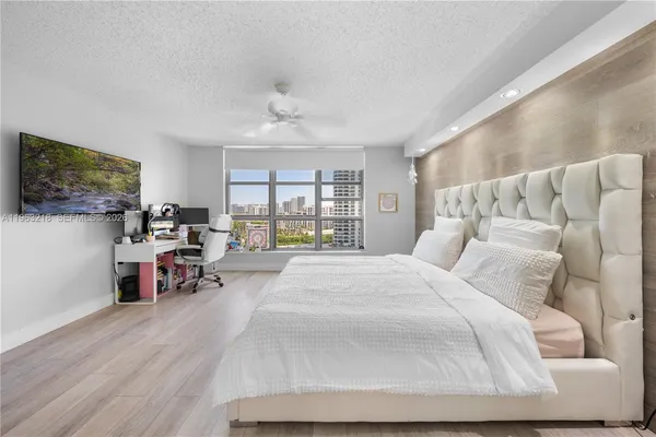 a bed room with a bed and a large mirror