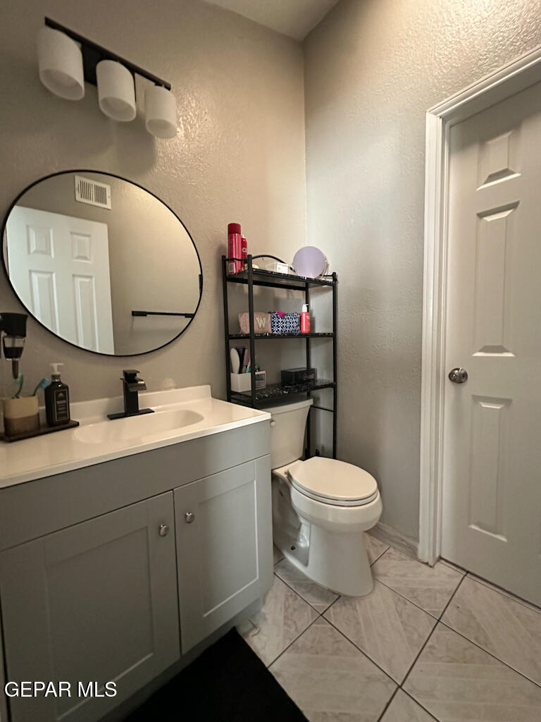824 Destello Road El Paso, TX 79907 - Photo 12 of 16 a bathroom with a toilet sink and mirror