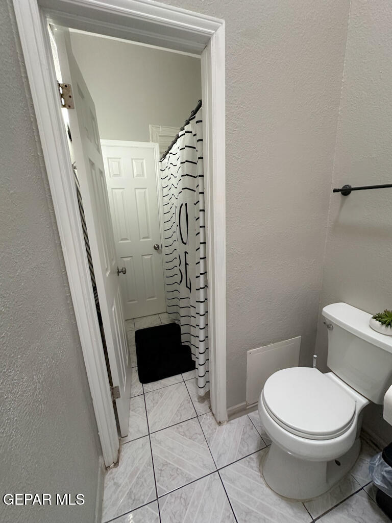 824 Destello Road El Paso, TX 79907 - Photo 14 of 16 a bathroom with a toilet and a shower