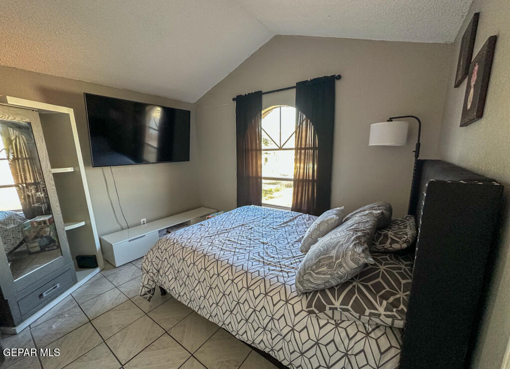 824 Destello Road El Paso, TX 79907 - Photo 10 of 16 a bedroom with a bed and a flat screen tv